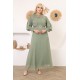 Evening dress with exquisite decoration and a green necklace